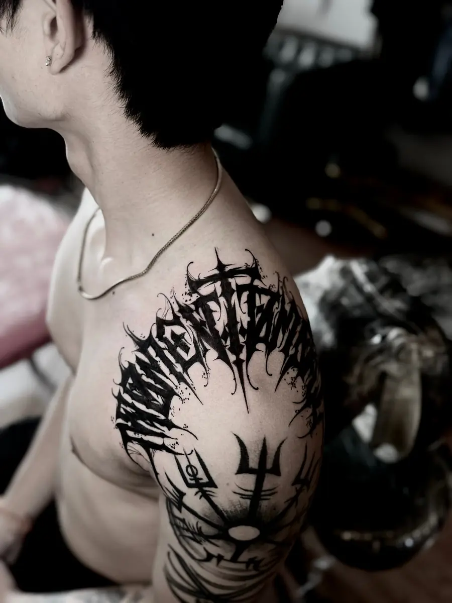 Angular black metal style lettering and a trident across a chest and shoulder