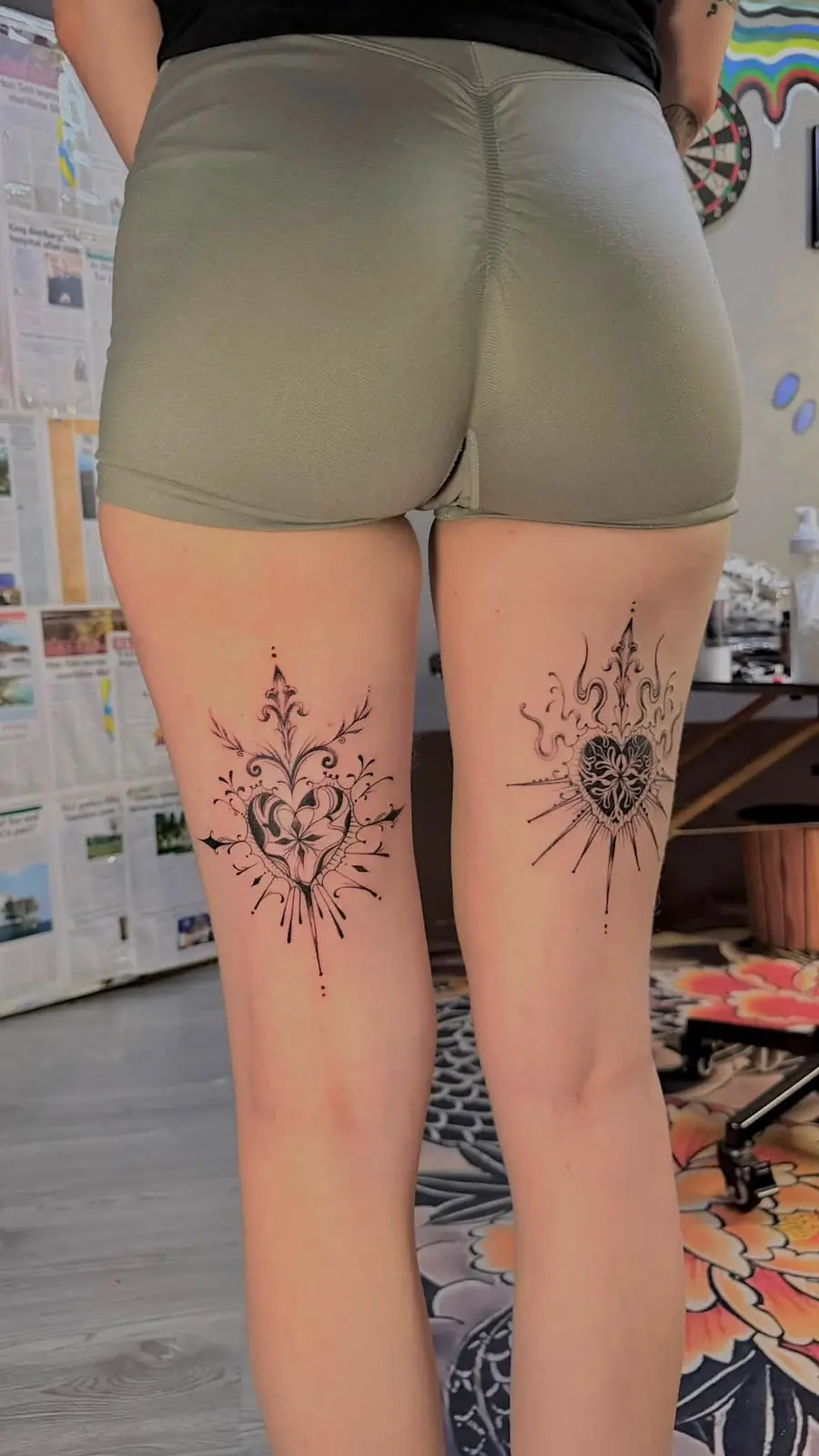 Matching fine line ornamental pieces on both calves