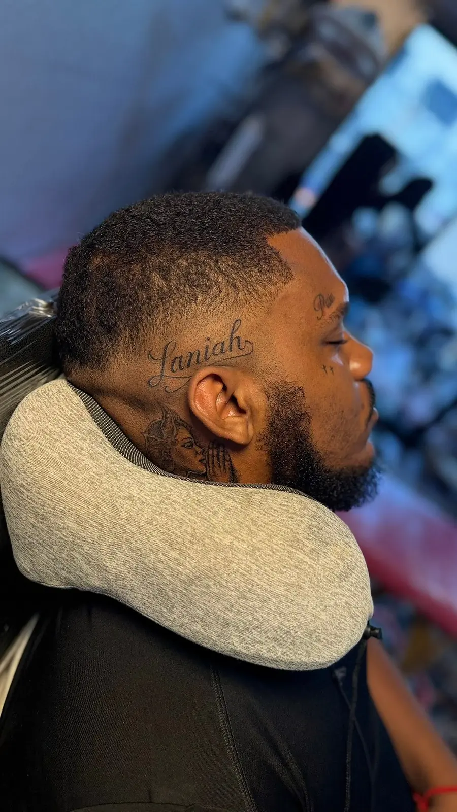 A name tattooed in fine script on the side of the neck