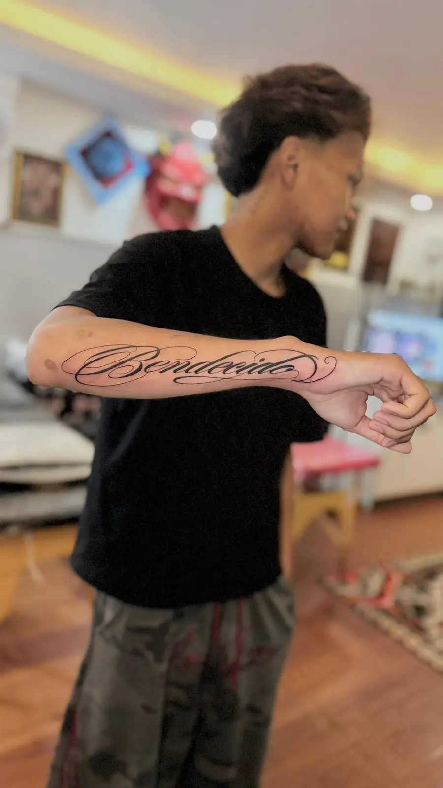 A name in fine flowing script along the inside of a forearm