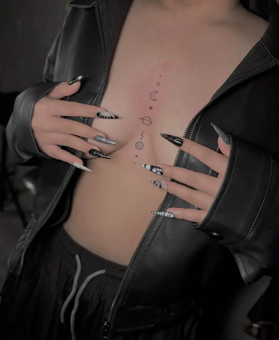 Fine line moon phases and small ornaments down the sternum